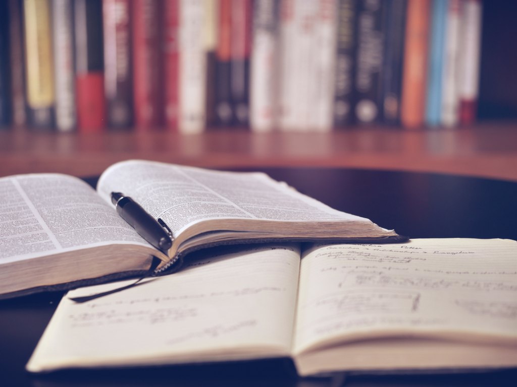 Books sitting out on a table in a library.